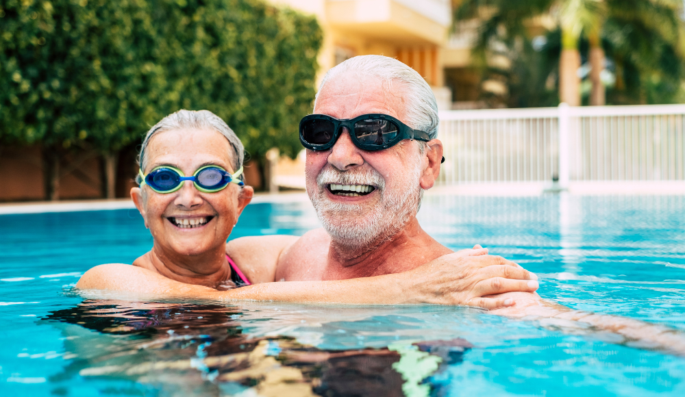 Elderly adults swimming in pool 